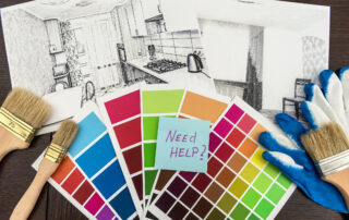 On office desk house sketch with color sample and brush. Workplace Architect. Drawing renovation house. how to pick a second paint color