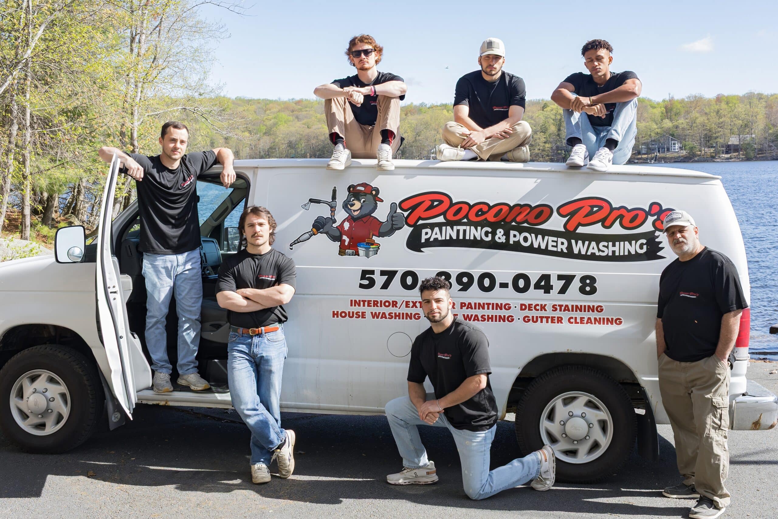 Pocono Pro’s Painting and Power Washing Team The Pocono Pro's Painting and Power Washing team poses with their branded service van by a lake.